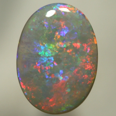 SOLID SEMI BLACK OPAL Large opal, red to blue to greens with a hint of gold. SEE VIDEO